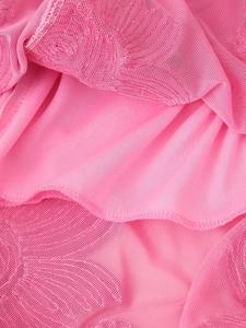 Macro detail of pink embroidered mesh fabric with high-quality stitching on dress