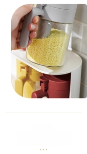 Detail view of the two-in-one seasoning jars with spoon lids and durable storage rack