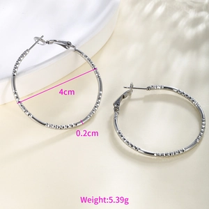 Detail showing 4cm silver chain-textured hoop earrings with weights and dimensions