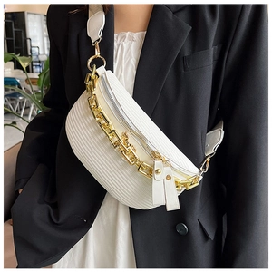Detail of white woven dumpling bag with gold chain strap and textured leather finish