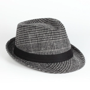 Detailed view of the plaid wool texture and black ribbon on a classic fedora hat