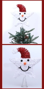 Macro detail of white glittery snowman star tree topper with a red hat and spring base