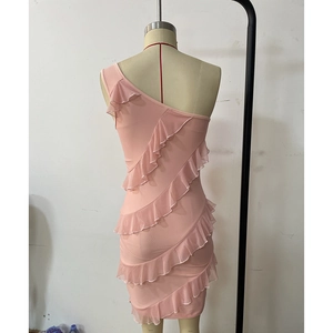 Detailed view of layered pink ruffles and one-shoulder design on a mini bodycon dress