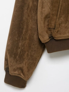 Detail of ribbed cuffs and hem on brown suede jacket with high-quality texture