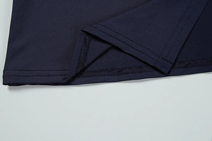 Close-up of the double-needle coverstitch hem on navy blue knit dress fabric