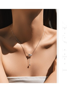 Macro shot of S925 silver Y-shaped necklace with emerald-cut geometric pendant on a model