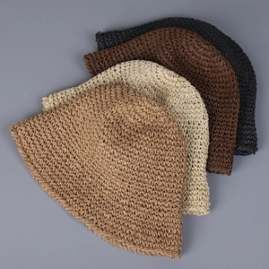 Detail of four colorful woven bucket hats showing textured straw patterns and material layers