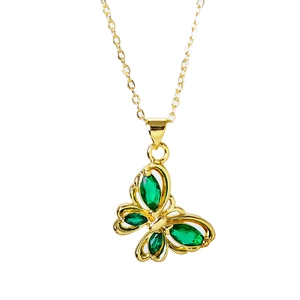 Elegant gold butterfly pendant necklace with green gemstone inlay on white background