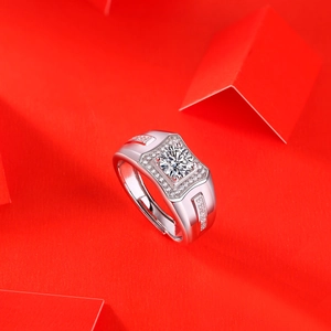 Detailed shot of silver men's ring with square moissanite on red geometric platform