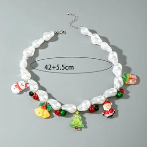 Close-up of Christmas necklace featuring snowman, tree, and bell charms with faux pearls