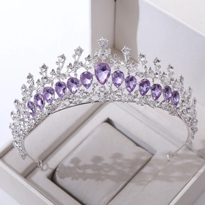 Macro detail of luxury bridal crown with purple crystals and rhinestones in a gift box