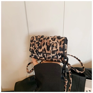 Detail of leopard print crossbody bag with double buckle closure and resin chain strap