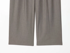 Detail of taupe straight-leg suit trousers showing high-quality twill fabric texture