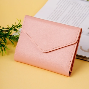 Detail of pink lychee leather wallet showing envelope flap and precision stitching