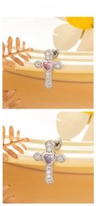 Detailed view of silver cross earrings with pink and lavender heart-shaped zircon stones
