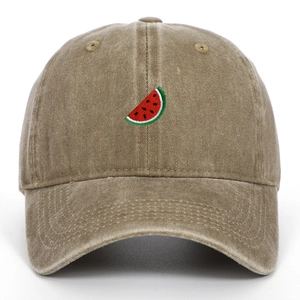 Close-up of the detailed watermelon slice embroidery on a khaki washed cotton baseball cap