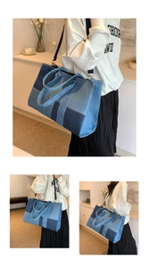 Detail of large denim tote bag featuring blue patchwork design and gold metal buckles