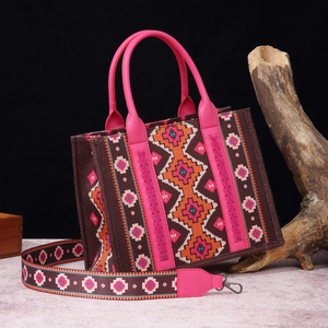 Macro view of bohemian printed canvas tote bag featuring pink handles and matching strap