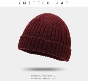Detail view of the fine knit texture and soft burgundy fabric of the winter beanie hat