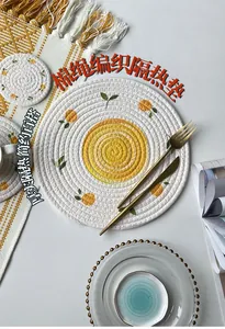 Macro shot of circular woven cotton insulated mats with vibrant citrus pattern prints