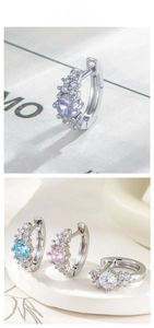 Macro shot of silver S925 earrings featuring colored cubic zirconia and pave side stones