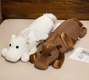 Detail of plush animal pillows with angel wings in soft white and brown fabric