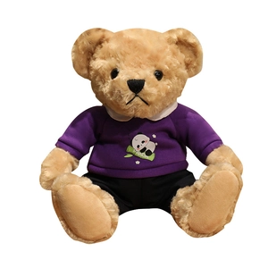 Plush brown teddy bear in a purple panda hoodie and black pants, sitting position