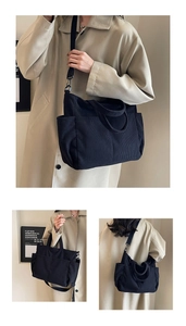 Detail of black corduroy tote bag showing multiple pockets and adjustable straps