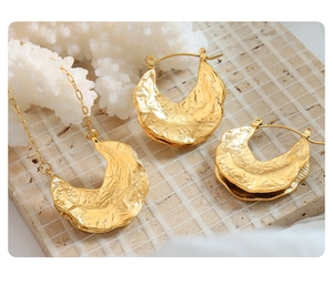 French style gold jewelry set with hammered crescent pendant and matching hoop earrings