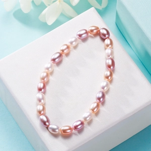 Elastic freshwater pearl bracelet with pink purple and white oval pearls on gift box