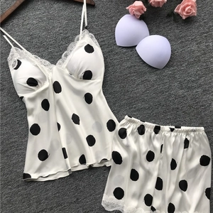 Silk satin polka dot pajama set with lace trim and camisole top on gray background