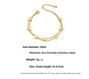 Close-up of double layer gold stainless steel chain bracelet with heart pendants