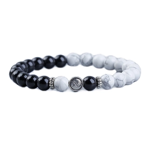 Yin Yang beaded bracelet with black beads, white turquoise, and metal Tai Chi charm