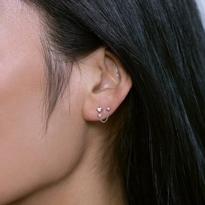 Close-up of S925 sterling silver double stud earrings with chain and shimmering crystals