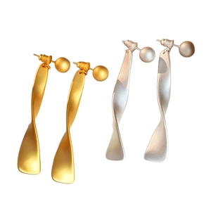 Modern twisted geometric earrings with brushed gold and silver drop design on white background