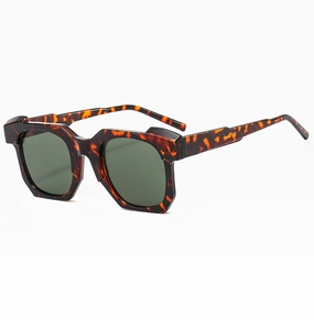 Detail view of retro chunky rectangular sunglasses with tortoiseshell frame and dark lenses