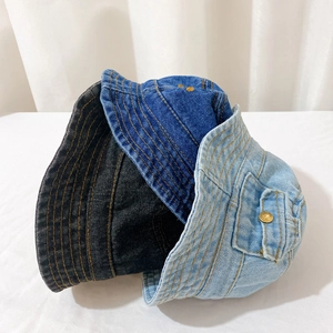 Three colors of denim bucket hats stacked with side button pocket detail and clean stitching