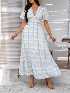 Detail of V-neck printed summer dress with elastic waist and ruffled sleeves in white and blue