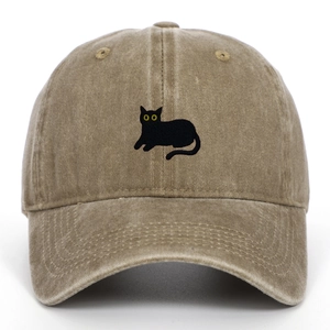 Detailed close-up of khaki washed cotton baseball cap featuring black cat embroidery