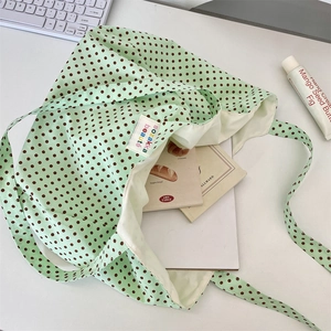 Detailed view of large polka dot canvas tote showing spacious interior for books