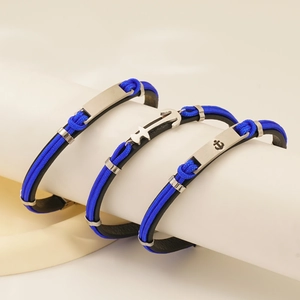 Close-up of three blue and black braided leather anchor bracelets with metal charms