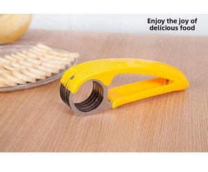Banana slicer detail with multi-layer stainless steel blades and yellow handle on wood