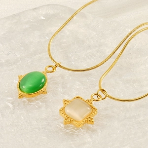French vintage gold snake chain necklace with green and cream cat eye stone pendants