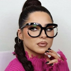 Modieus oversized cat-eye brilmontuur in zwart en goud op een stijlvol vrouwelijk model