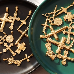 Assorted 18K gold plated stainless steel cross and religious medallion pendants on plates