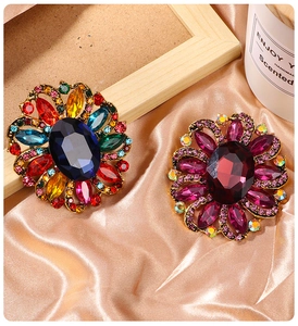 Detailed macro view of vintage diamond floral brooches with colorful rhinestones and crystals