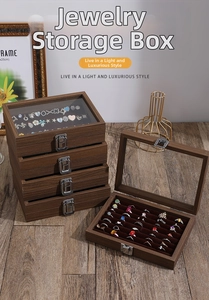 Detailed view of 5-layer walnut wood jewelry box with glass top and silver metal clasp