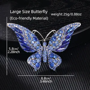 Macro view of large butterfly brooch with blue crystals measuring 8.8cm by 5.8cm