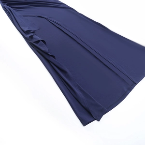 Detailed view of the elegant high-slit hem on a navy blue knit strapless maxi dress