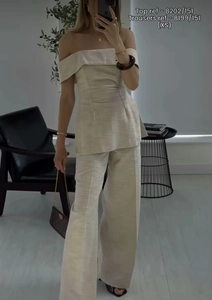 Mirror selfie showing texture of beige off-shoulder top and wide-leg trousers set